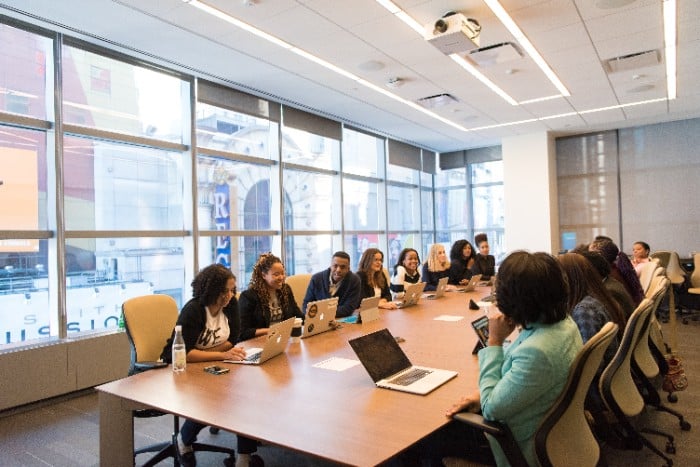 Full-time MBA students sitting around large table