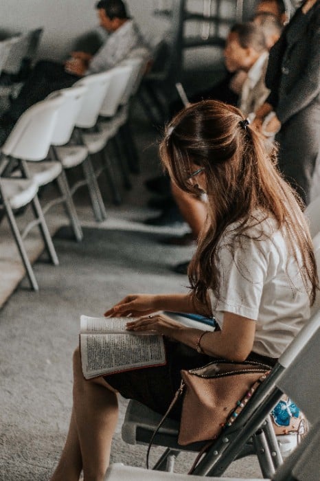 Girl sitting caught in the DBA vs PhD dilemma