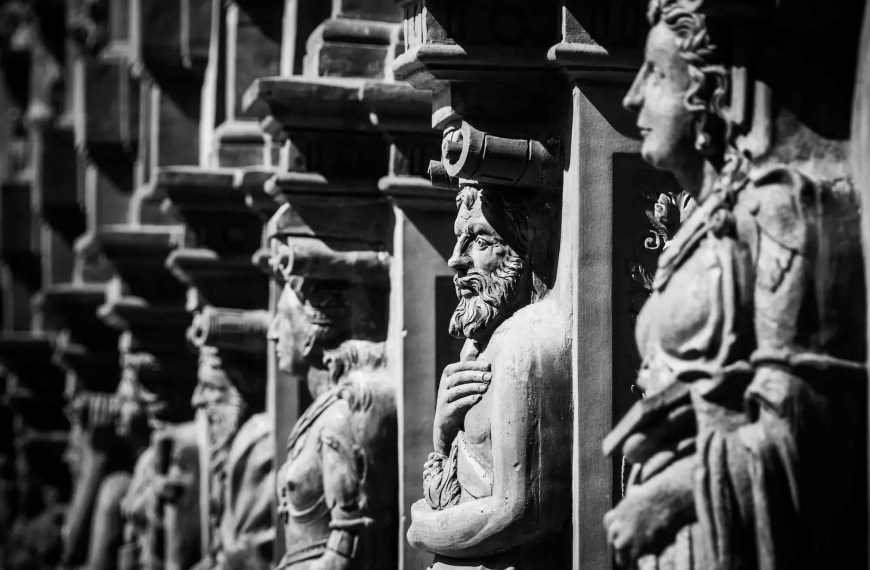 Stone statues representing historical figures — symbolizing research depth and focus for a History Statement of Purpose