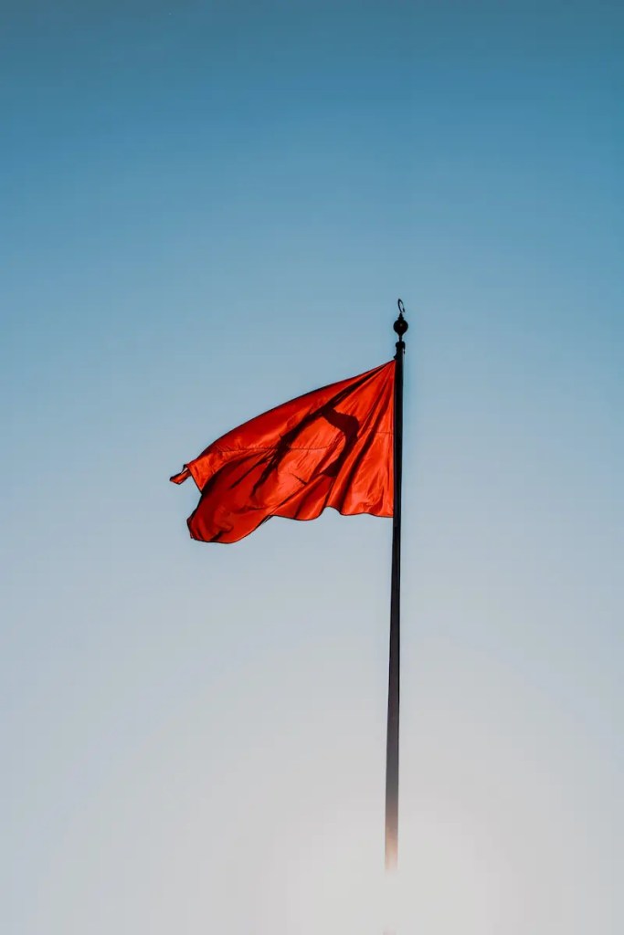 Red flag in sky with wind