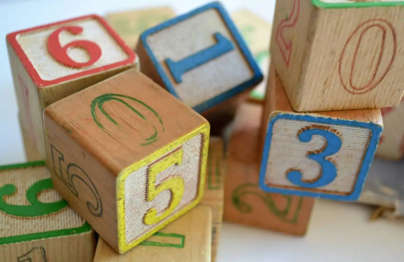 Stack of colorful wooden number blocks used for early childhood learning and play as symbol for GPA for grad school