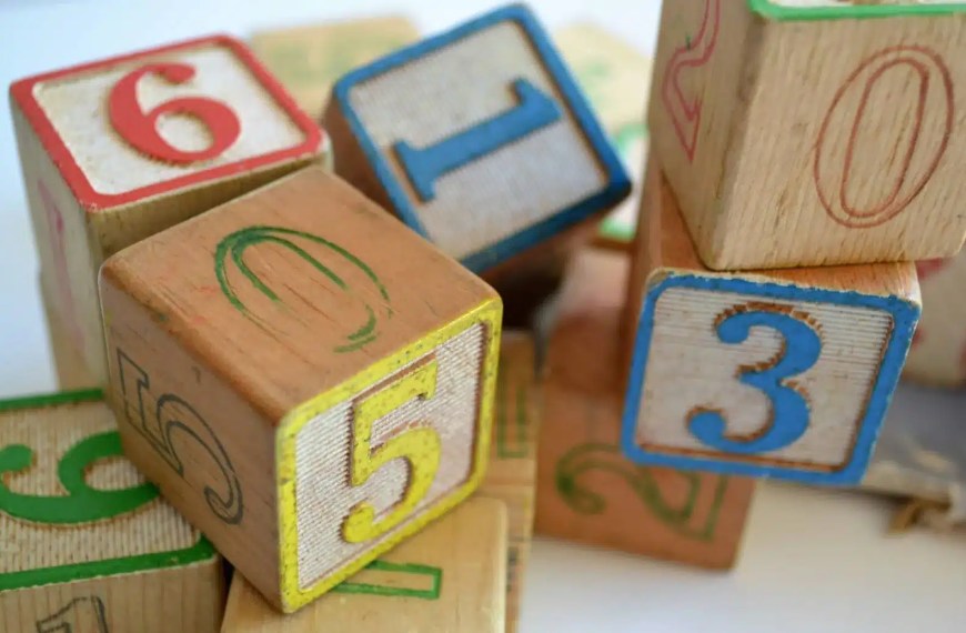 Stack of colorful wooden number blocks used for early childhood learning and play as symbol for GPA for grad school