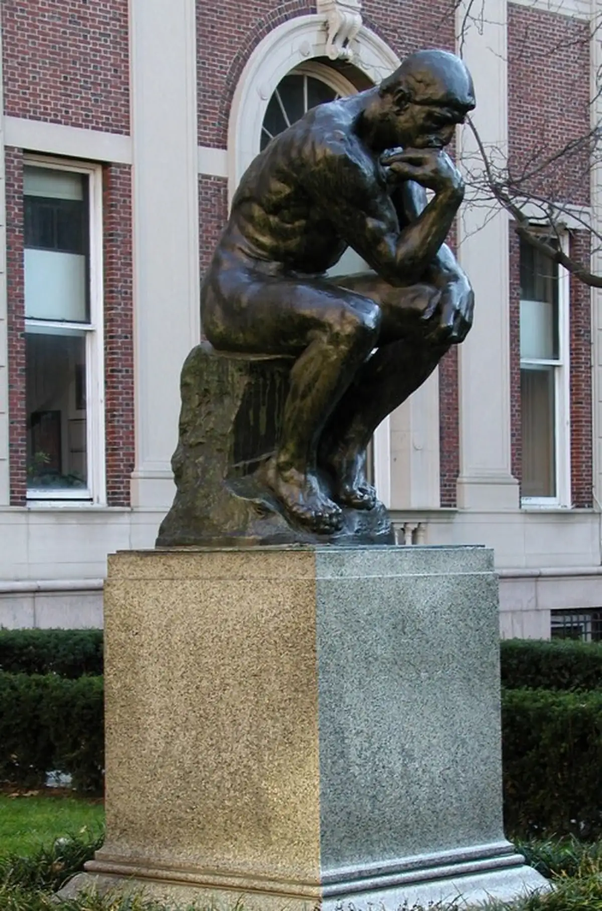 odin’s The Thinker sculpture on a pedestal in front of a university building