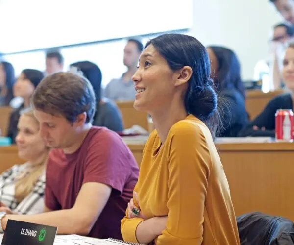 Group of students engaging in classroom discussion at Wharton — Wharton MBA interview preparation setting