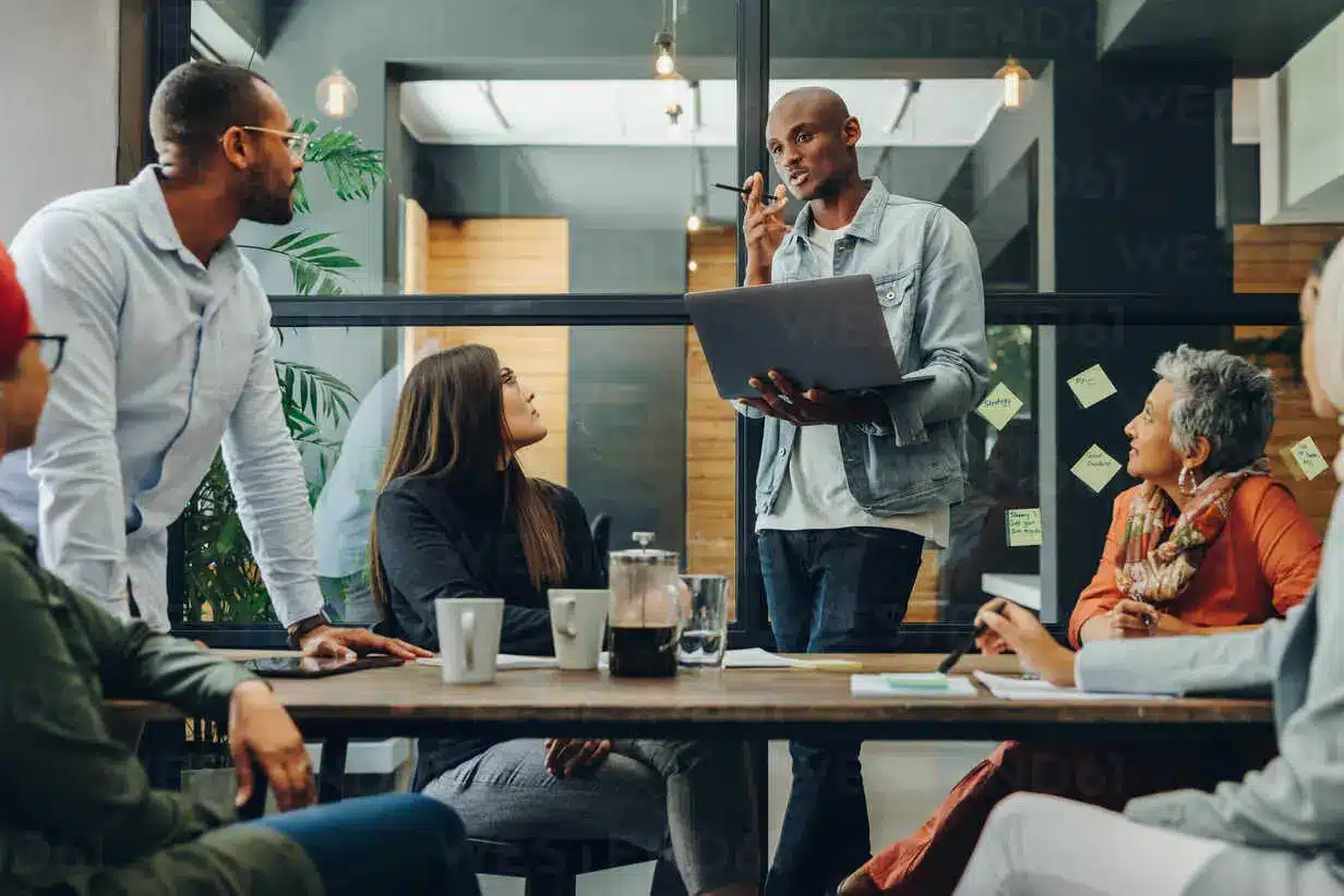 Business professionals discussing career paths — Master’s in Management vs MBA