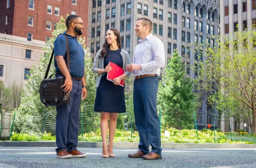 Young professionals discussing master’s in management degree outcomes