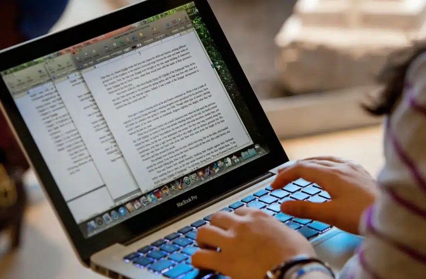 Stanford MBA essays applicant writing on laptop