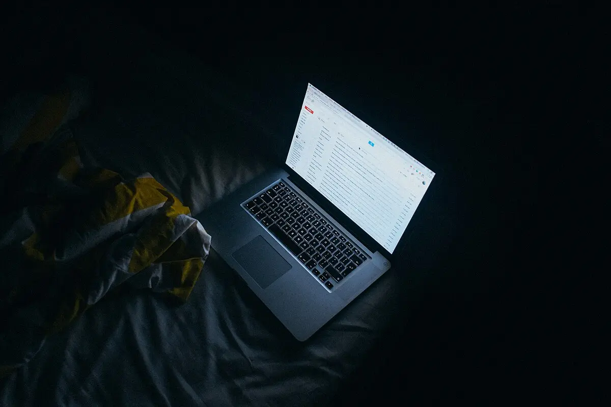 rejected from all phd programs student reading decisions on a laptop at night